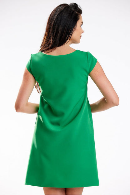 Back view of a sophisticated green mini dress with short sleeves and a trapezoidal cut, designed by awama for enhanced comfort and elegance.