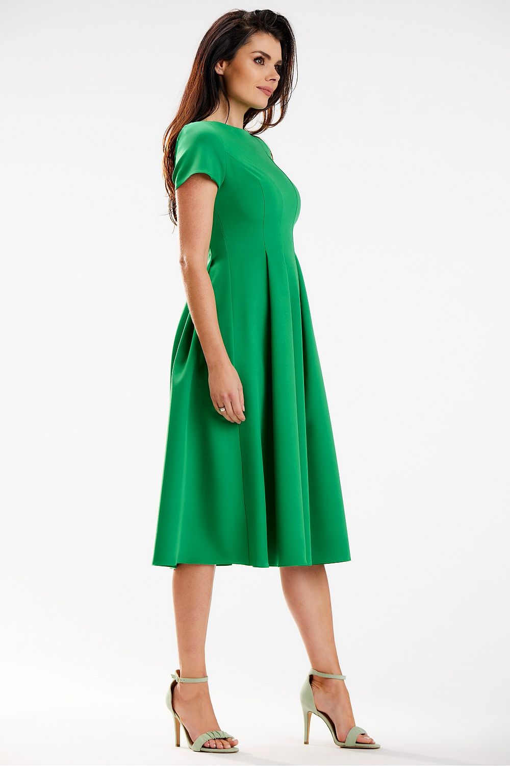 Side view of the luxurious green midi dress by Awama with a boat neckline and expertly crafted pleats, offering a sophisticated figure-enhancing fit.