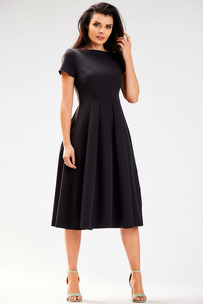 Chic black midi dress by Awama, designed with a boat neckline and short sleeves, accentuating a timeless silhouette.