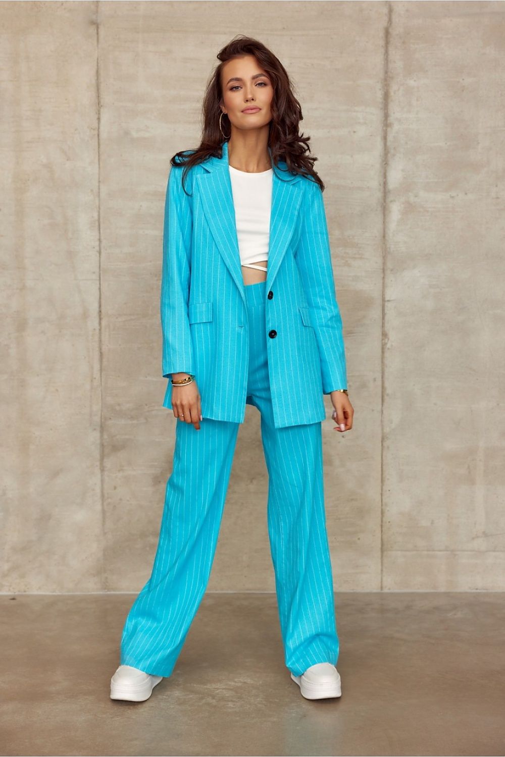 Stylish outfit by Roco Fashion showcasing a matching turquoise striped suit with wide cut trousers and a tailored blazer, perfect for sophisticated occasions.
