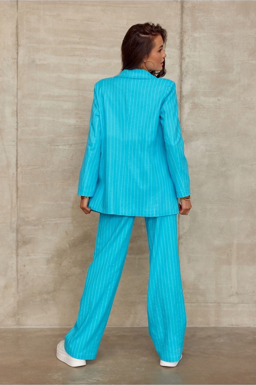 Roco Fashion's sophisticated turquoise striped suit, viewed from the back, highlighting the elegant design of the blazer and wide cut trousers for a luxurious look.