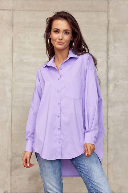 Elegantly dressed model showcasing Roco Fashion Women's oversized long sleeve shirt in pastel purple, featuring an asymmetrical hem and sophisticated collar against a minimalist background.