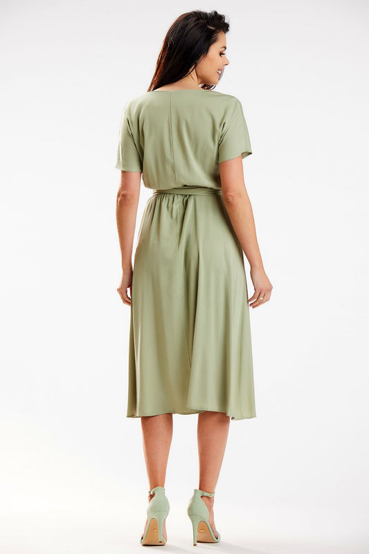 Back view of the luxurious midi length kimono dress by Awama in soft green viscose, highlighting the elegant sash and airy design.