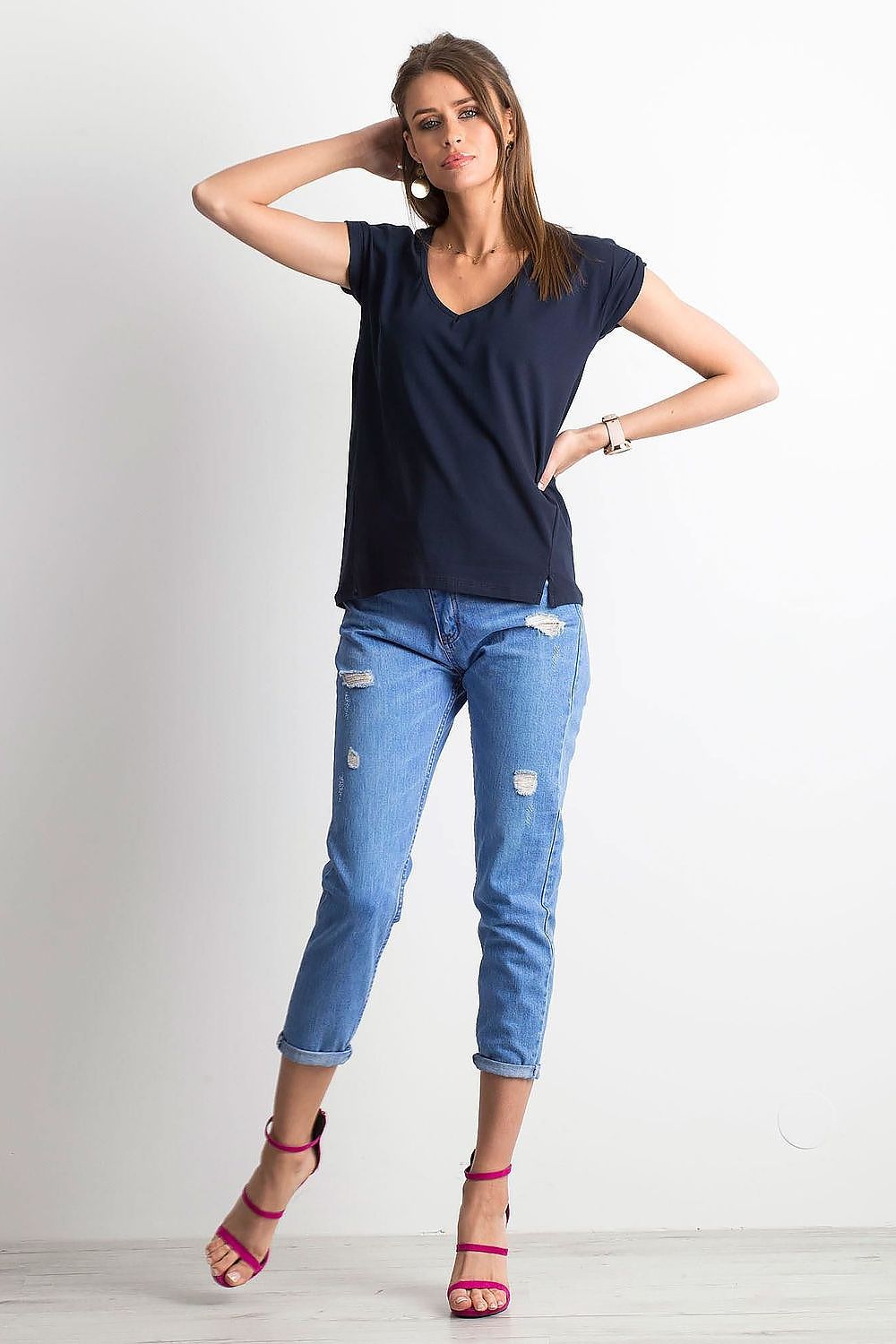 Fashionable women's navy V-neck t-shirt by BFG, paired with distressed denim for a modern yet elegant outfit.