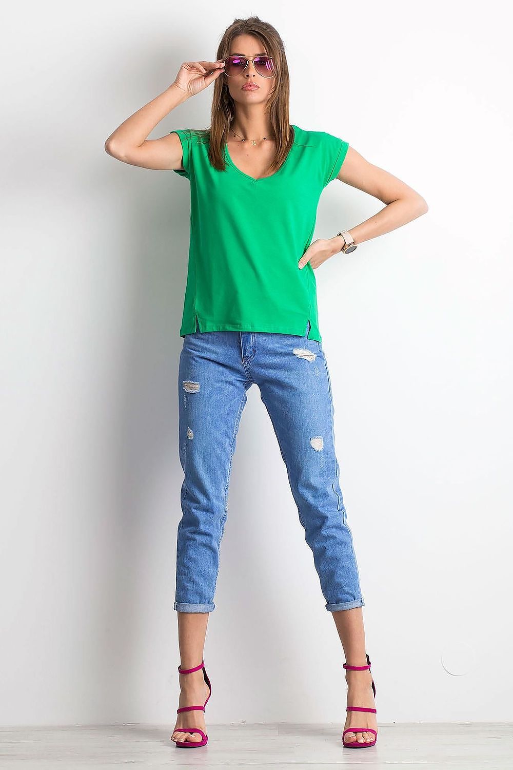 Trendy women's green V-neck t-shirt by BFG, elegantly styled with modern accessories and denim for a luxe casual look.