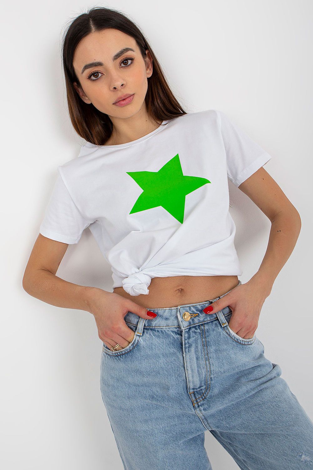 Luxury women's white cotton spandex BFG T-shirt featuring a vibrant green star print, styled with rolled sleeves and a knotted front for a chic casual look.