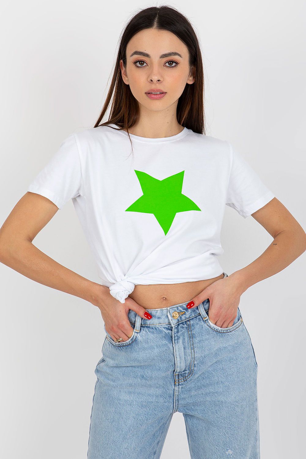 Elegant women's white cotton spandex BFG T-shirt adorned with a striking green star print, casually knotted at the waist for a trendy appearance.