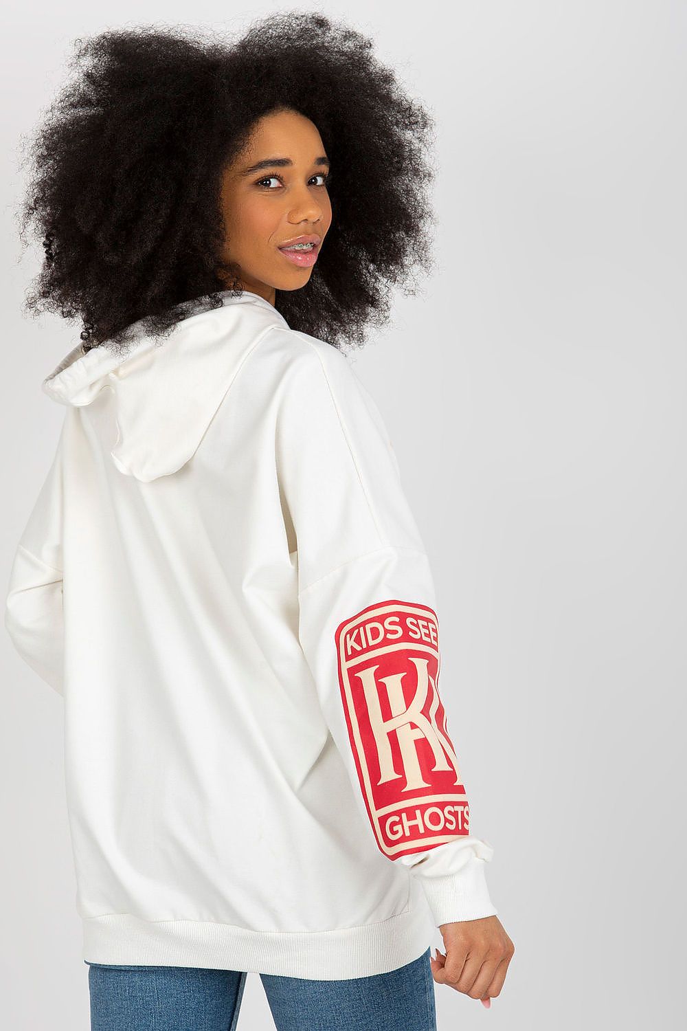 Chic view of the back of a white women's hoodie by Fancy, showcasing eye-catching lettering on the sleeve and a stylish hood, perfect for a trendy casual look.