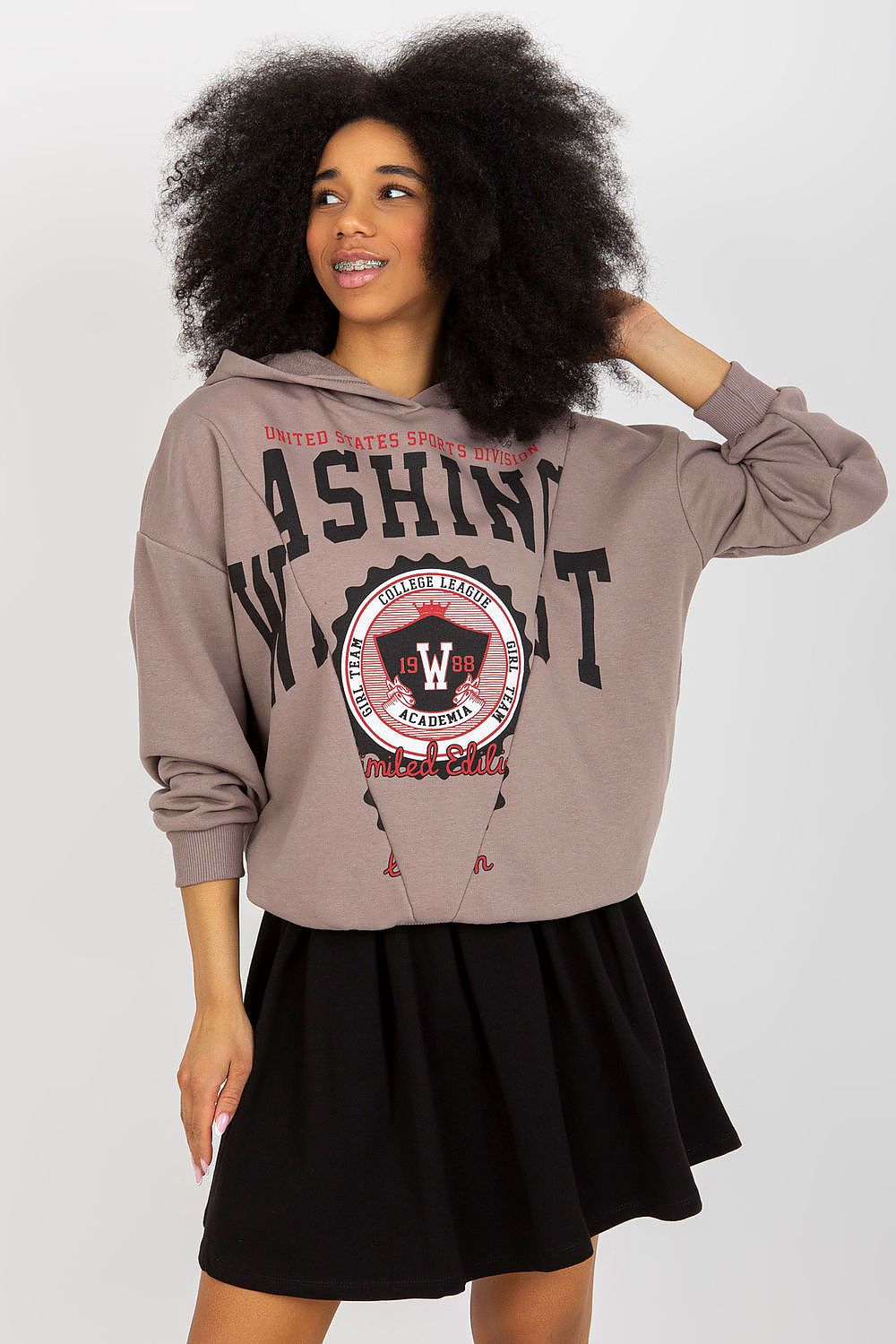 Elegant model showcasing a luxury cotton spandex sweatshirt and skirt set by Fancy, featuring a decorative print and hood, perfect for casual chic looks.