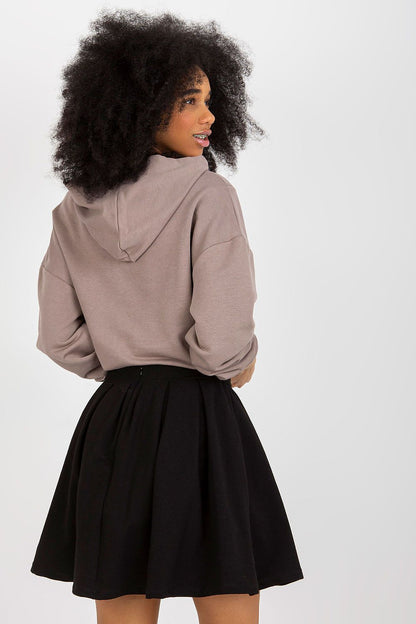 Back view of a fashionable model in a luxury cotton spandex sweatshirt and skirt set by Fancy, emphasising the flattering flared skirt and comfortable fit.