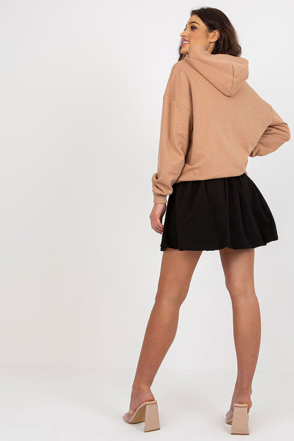 Elegant rear view of a model wearing a luxury cotton spandex sweatshirt and skirt set by Fancy, featuring a hood and decorative design, ideal for chic casual outings.