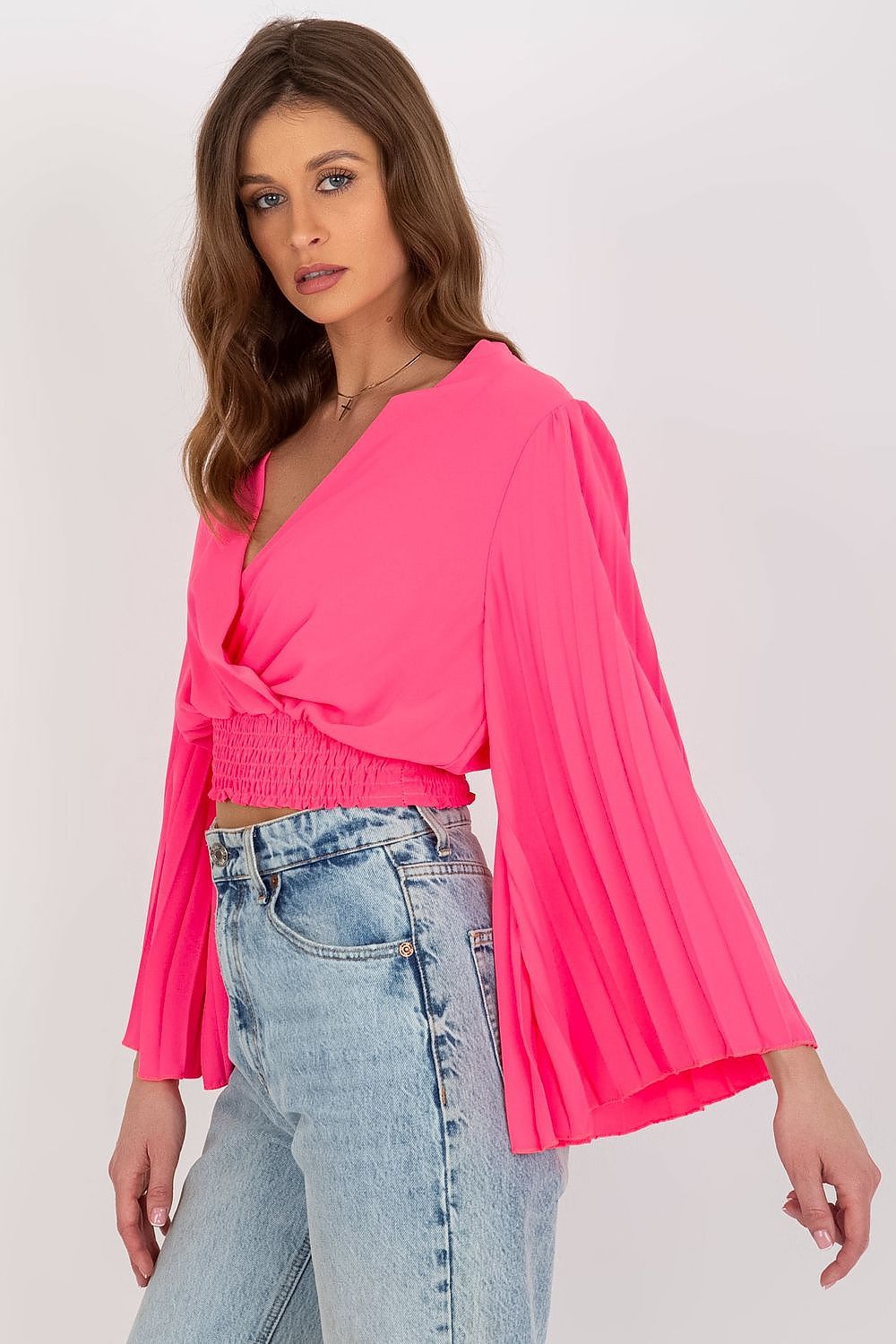 Stylish Italy Moda blouse showcasing pleated sleeves and an envelope neckline in a bold pink hue, complemented by high-waisted denim jeans.