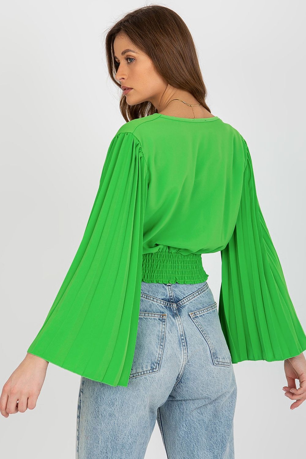 Back view of a premium green blouse by Italy Moda, designed with pleated long sleeves and a fitted waist, combined with stylish high-waisted jeans.