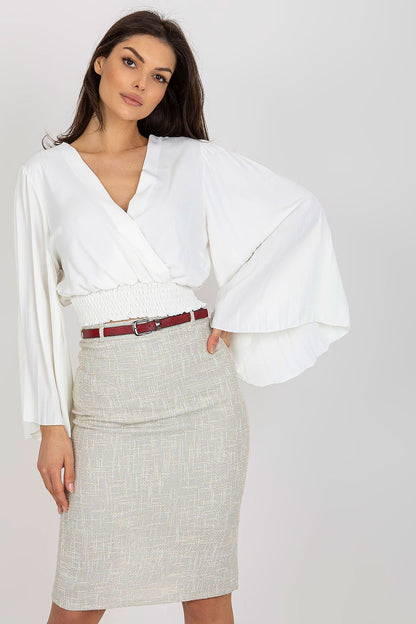 Chic white blouse by Italy Moda with pleated long sleeves and envelope neckline, elegantly styled with a pencil skirt and a statement belt.