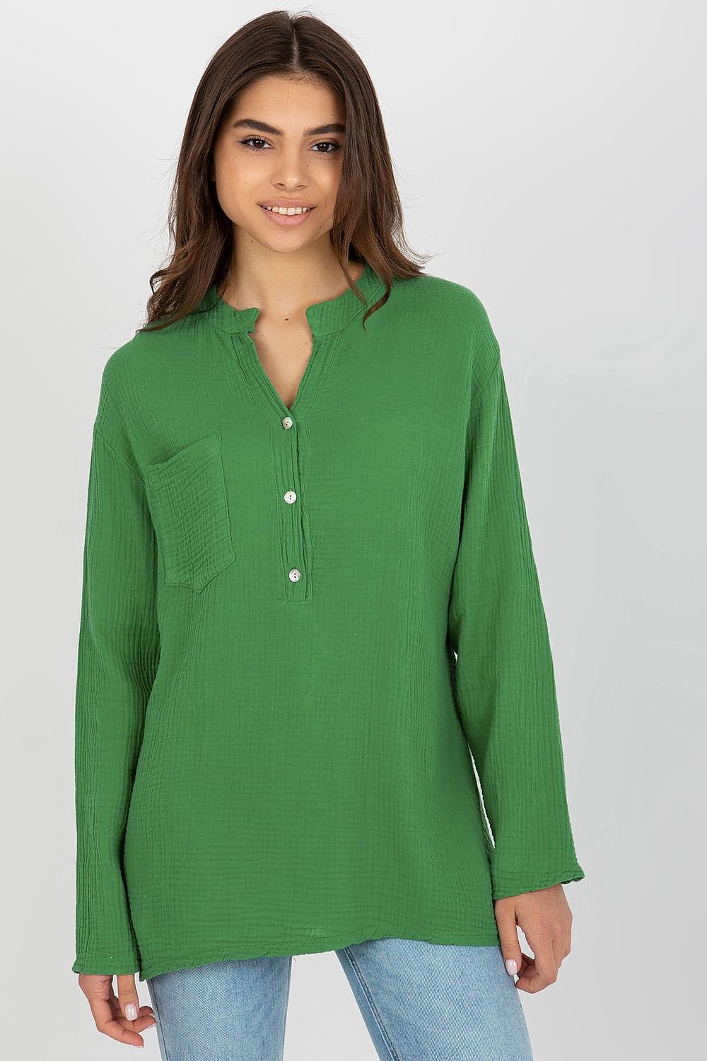 Och Bella luxury muslin blouse in vibrant green, featuring a loose fit, long sleeves, and a stylish v-neck with button closure, complemented by a chic front pocket.