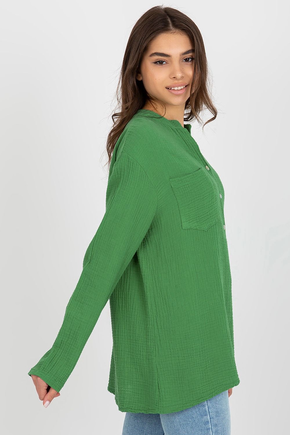 Side view of the Och Bella muslin blouse in green, highlighting its long sleeves and relaxed silhouette, a perfect blend of sophistication and comfort in luxury apparel.
