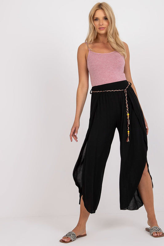 Elegantly styled high-waist trousers by Och Bella, featuring a decorative waist tie and a light, airy viscose fabric, showcasing a model in a chic pose.