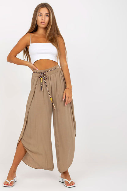 Front view of chic high-waist trousers from Och Bella in a soft taupe colour, featuring a decorative waistband, styled perfectly for a fashionable ensemble.