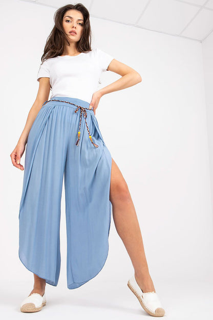 Chic blue high-waist trousers by Och Bella, designed with a decorative waist tie, presented in a flattering pose with stylish casual footwear.