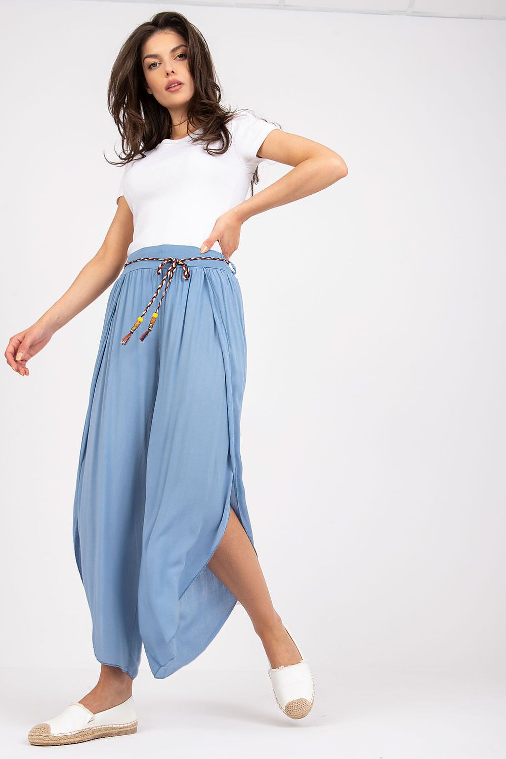 Stylish blue high-waist trousers by Och Bella, accentuated with a decorative waist tie, captured in an elegant pose for a luxury fashion look.