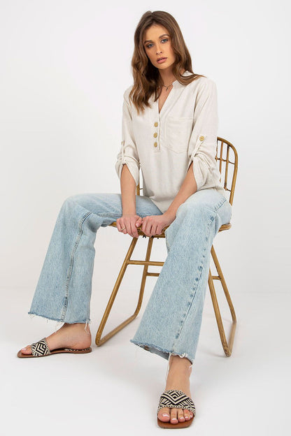 Elegant Rue Paris blouse made from a soft cotton blend, showcasing long sleeves and a heart-shaped neckline, paired with relaxed jeans for a chic look.