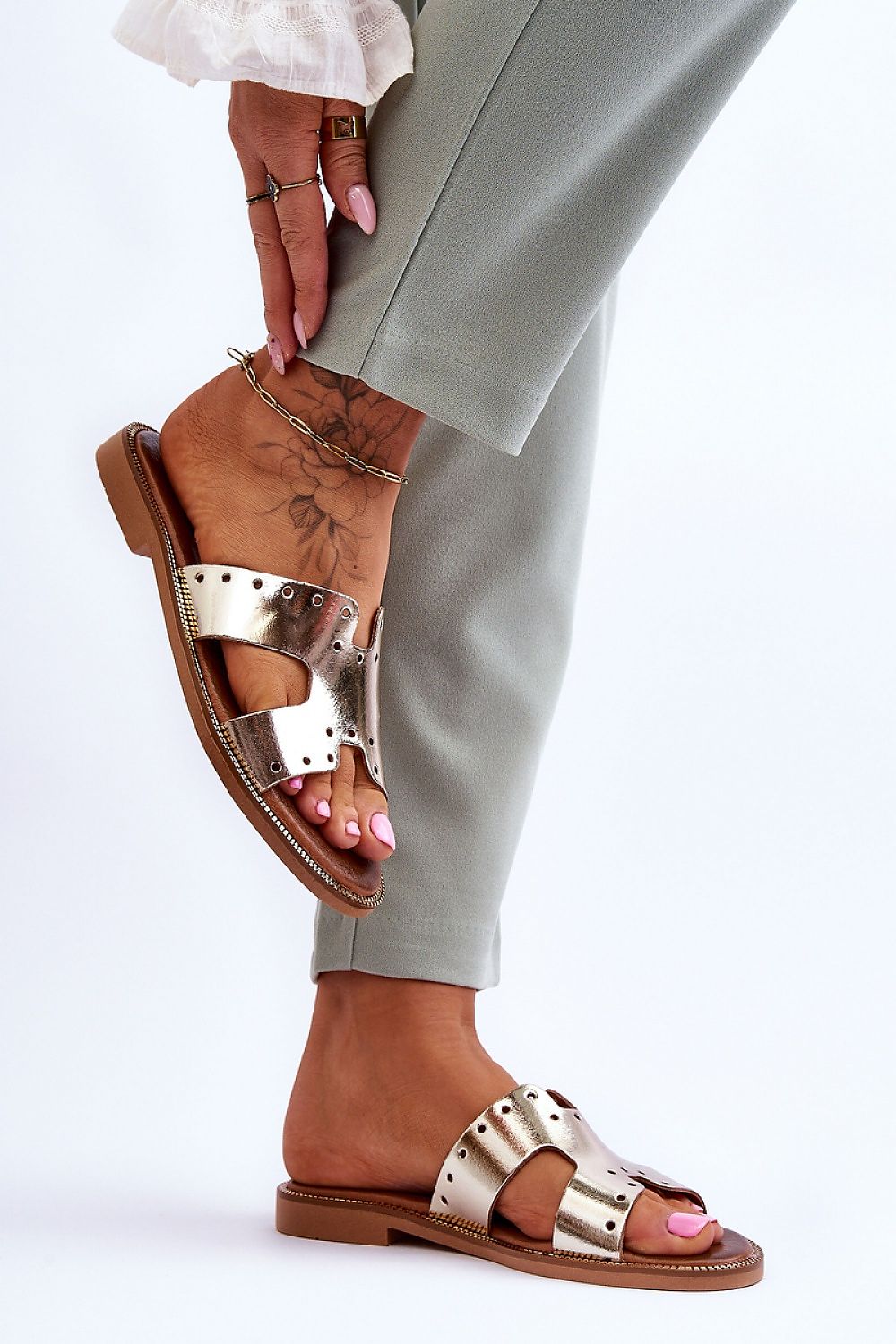 Sophisticated natural leather flip-flops by Step in Style, showcasing intricate cutouts and a plush footbed for all-day comfort.