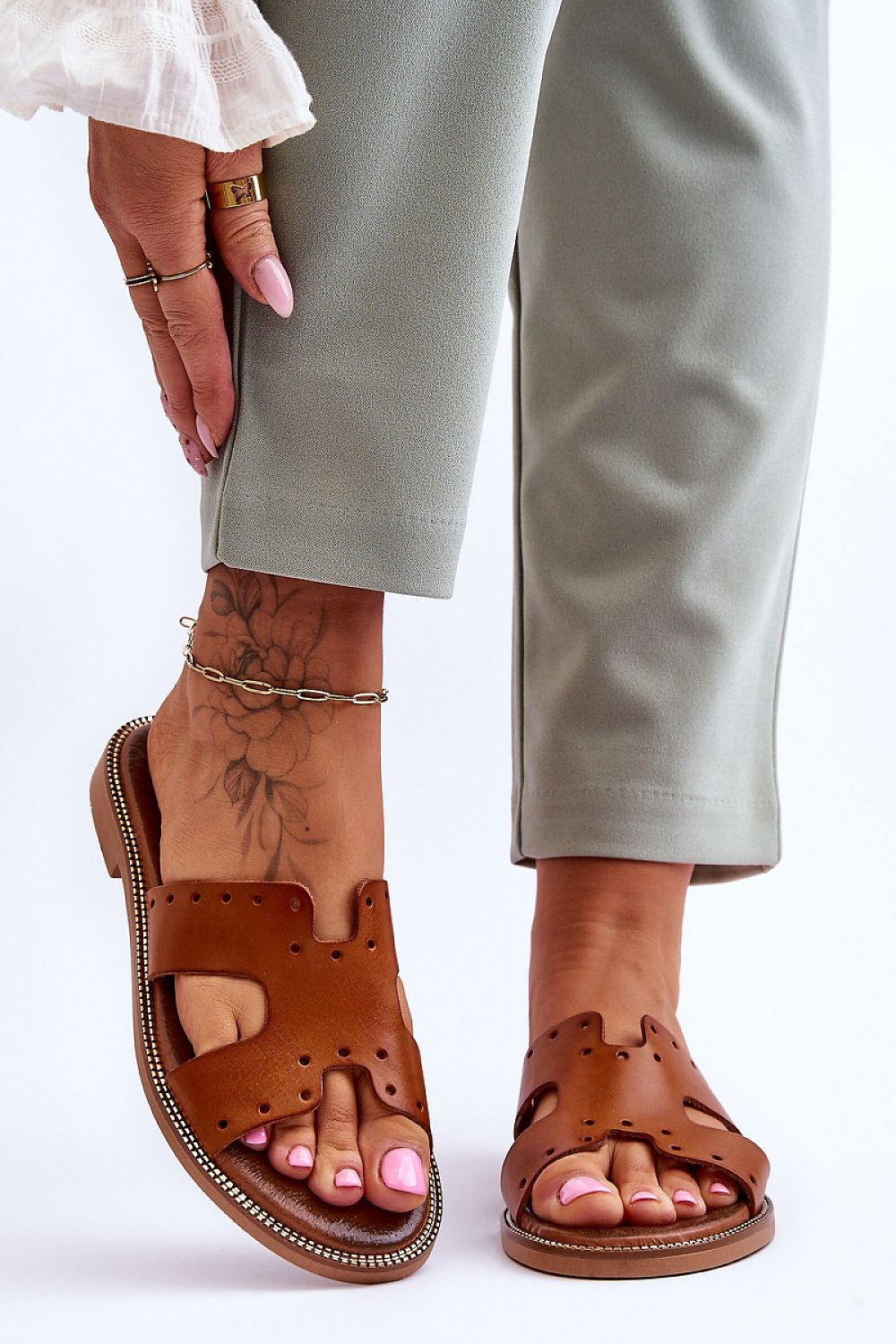 Chic brown leather flip-flops designed by Step in Style, featuring fashionable perforations and a comfortable footbed ideal for casual elegance.