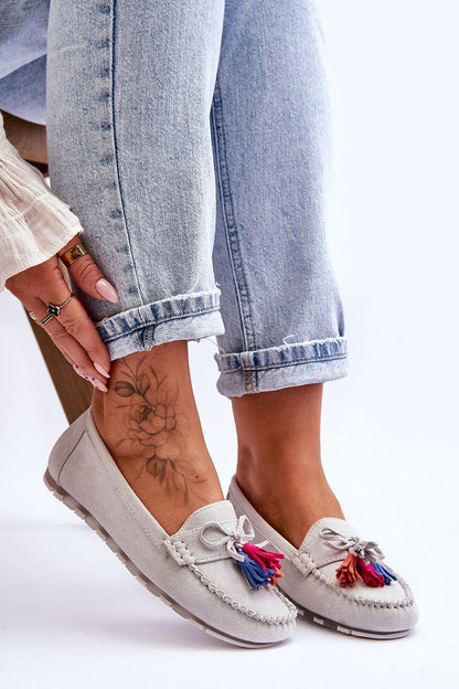 Luxurious women's eco-suede moccasins by Step in Style, featuring natural leather insole, decorative bow, and tassels, worn elegantly with denim.