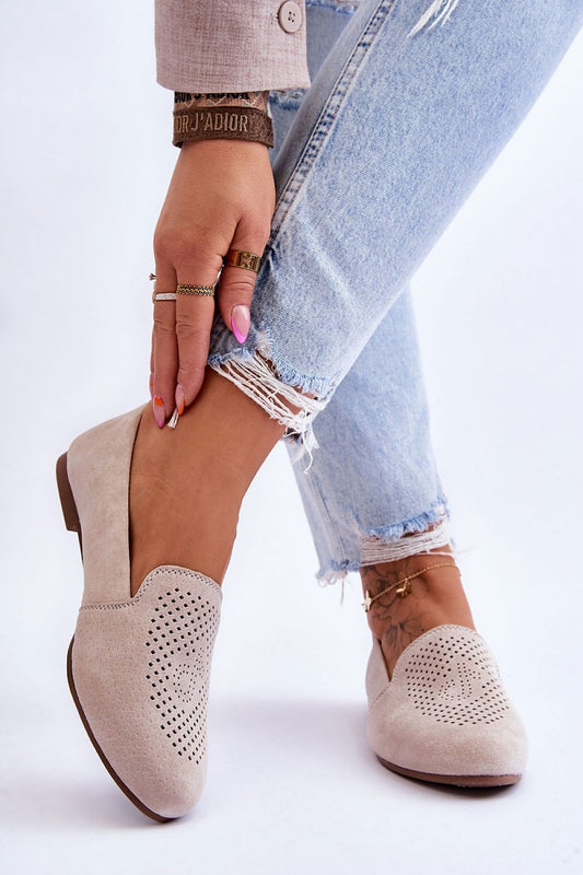 Luxury women's suede moccasins with decorative openwork design, showcasing comfort insole and flat heel, modeled by a fashion-forward individual in stylish denim.
