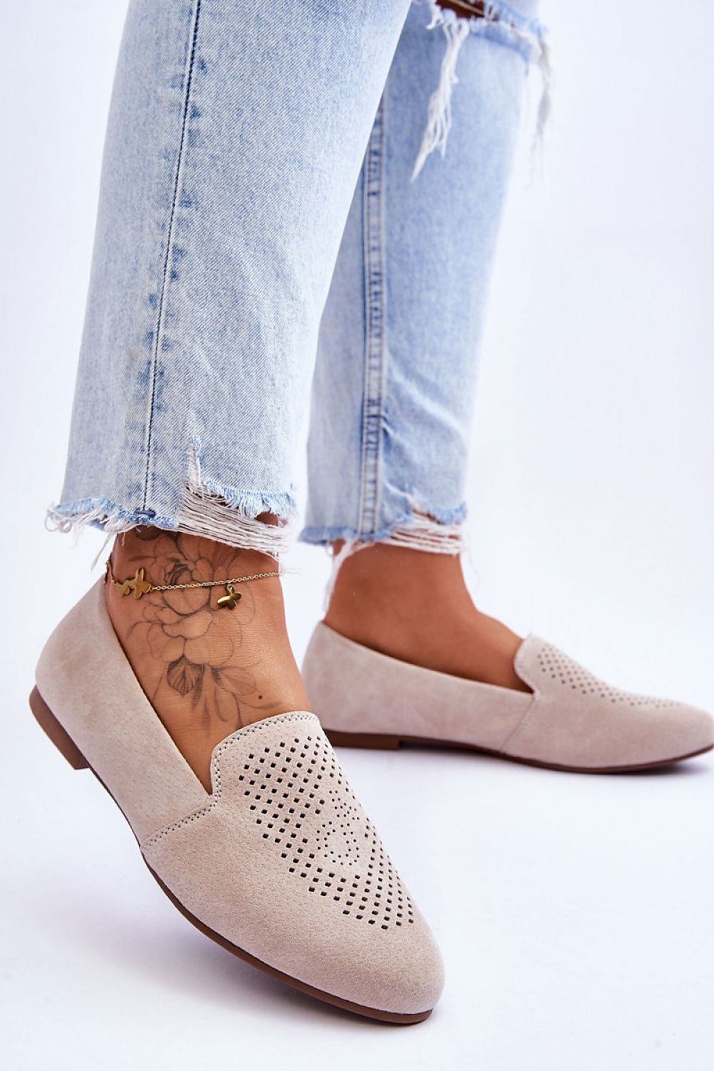 Luxury women's suede moccasins from Step in Style, featuring a decorative openwork design and comfort insole, elegantly styled with distressed blue denim jeans.