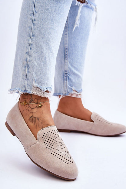 Luxury women's suede moccasins from Step in Style, featuring a decorative openwork design and comfort insole, elegantly styled with distressed blue denim jeans.