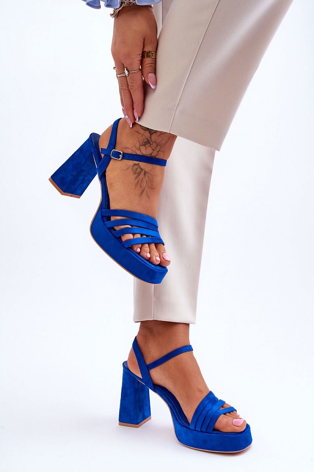 Striking blue eco suede high heel sandals with adjustable strap, elegantly paired with stylish beige pants, brought to you by Step in Style.