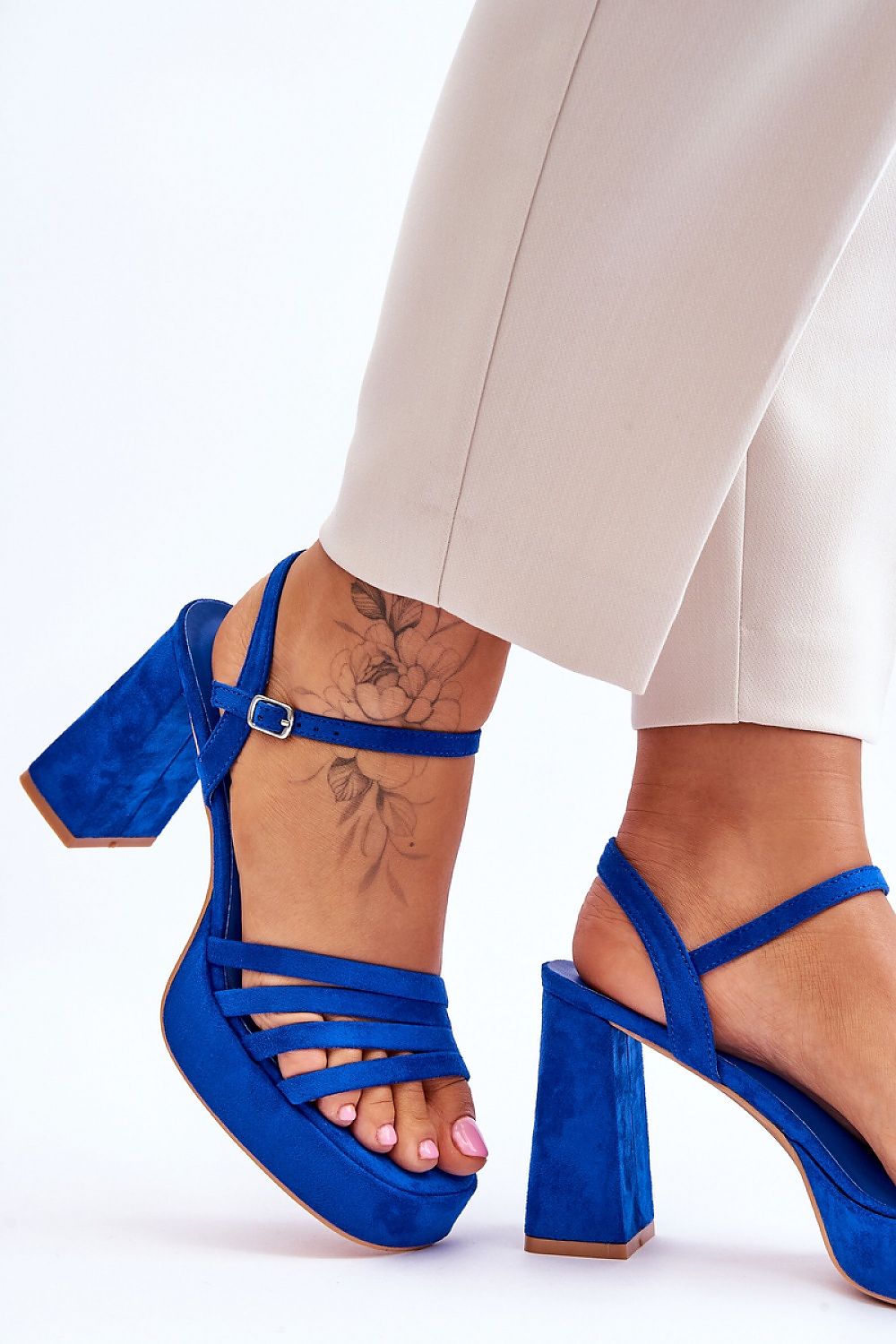 Sophisticated blue heeled sandals with ankle strap highlighted in a fashion-forward outfit, showcasing luxury from Step in Style.