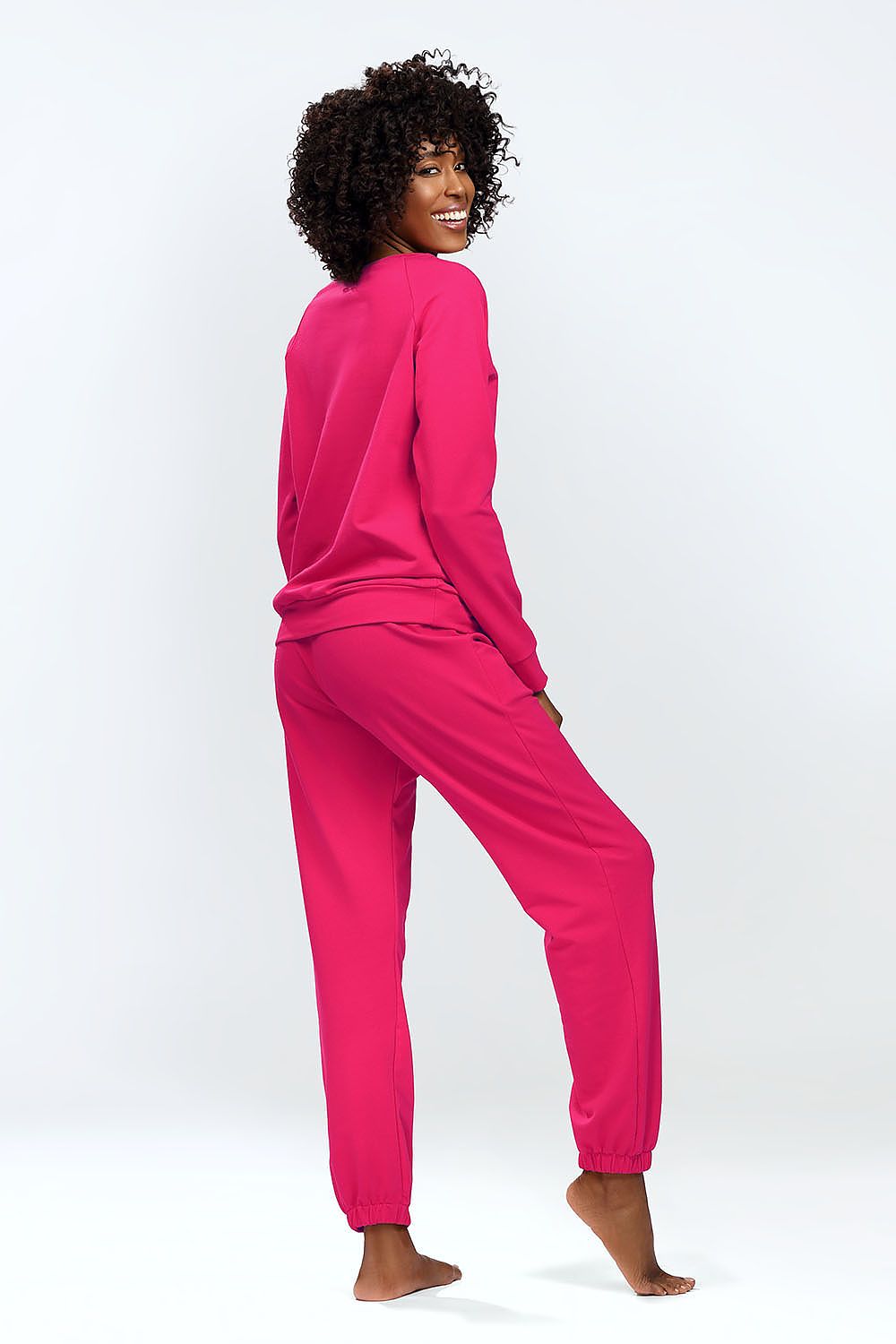 Graceful back view of the DKaren Venezia sweatshirt and sweatpants set in vibrant pink, epitomising luxury and comfort.