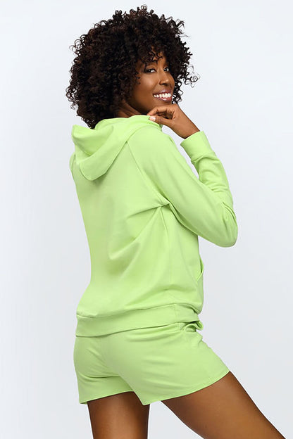 DKaren luxury hoodie and shorts set in vibrant green, model showcasing the soft cotton blend fabric with a seamless casual elegance, radiant smile and stylish outfit. Ideal for relaxed and sophisticated lounging.