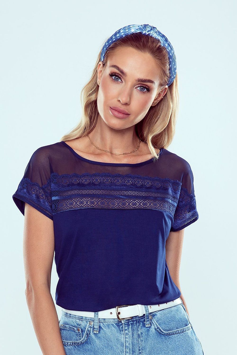 Eldar Luxury Batwing Blouse featuring lace insert details and short sleeves, worn by a stylish model with a chic headband.