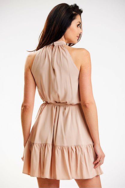 Back view of an elegant loose flared daydress by Awama featuring a distinctive neckline and versatile waist tie, model presenting its refined details.
