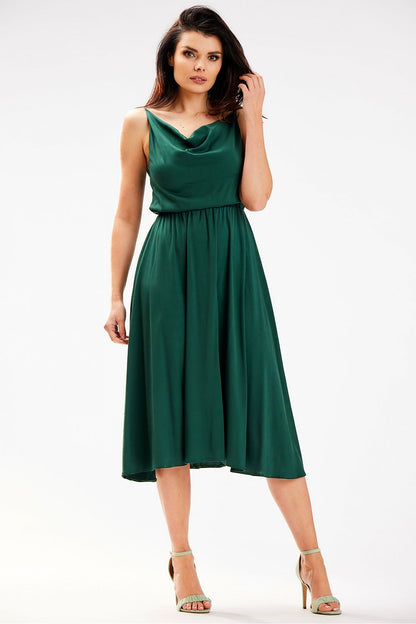 Stunning Awama midi dress in deep green, featuring a flowing silhouette and cowl neckline, elegantly posed from the front.