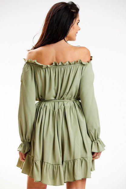 The back view of a sophisticated Awama Spanish A-Line dress in soft green, highlighting its flowing silhouette and stylish waist tie, perfect for modern elegance.