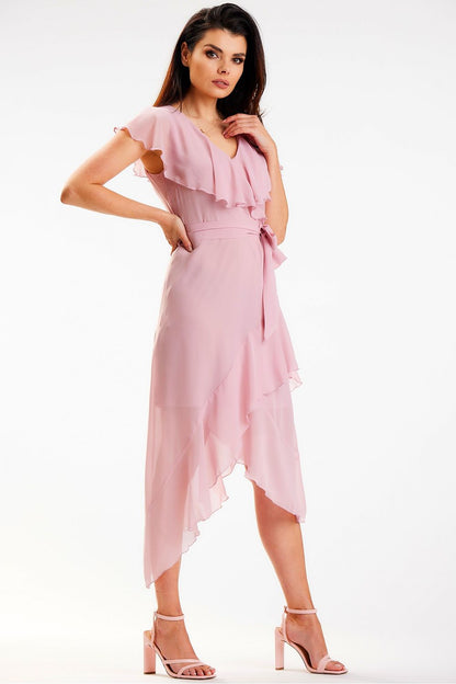 Elegant pink asymmetrical daydress with ruffle detail and V-neckline, designed by Awama. Model showcases the dress with a graceful pose, highlighting the flowing fabric and stylish design.