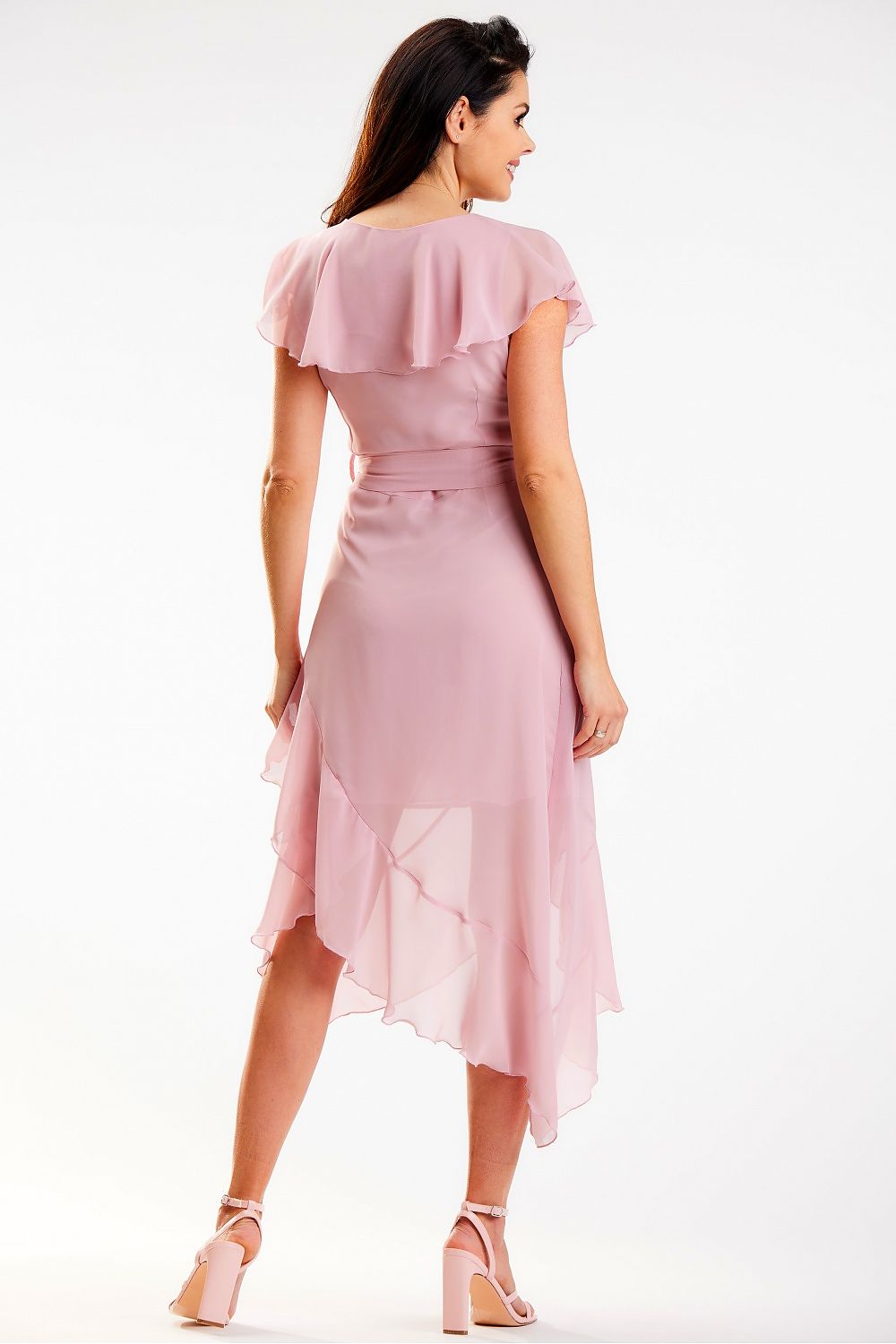 Sophisticated view of the back of the elegant pink asymmetrical daydress by Awama, featuring ruffle details and a flattering fit. Model captures the delicate flow of the dress, ideal for luxurious occasions.