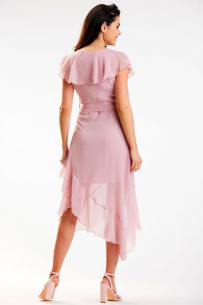 Sophisticated view of the back of the elegant pink asymmetrical daydress by Awama, featuring ruffle details and a flattering fit. Model captures the delicate flow of the dress, ideal for luxurious occasions.
