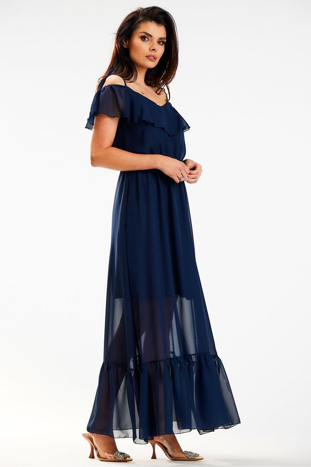 Side view of an elegant Spanish-style maxi dress with ruffle and elastic waist in airy chiffon by Awama, featuring a flowing silhouette and delicate details that embody luxury fashion.