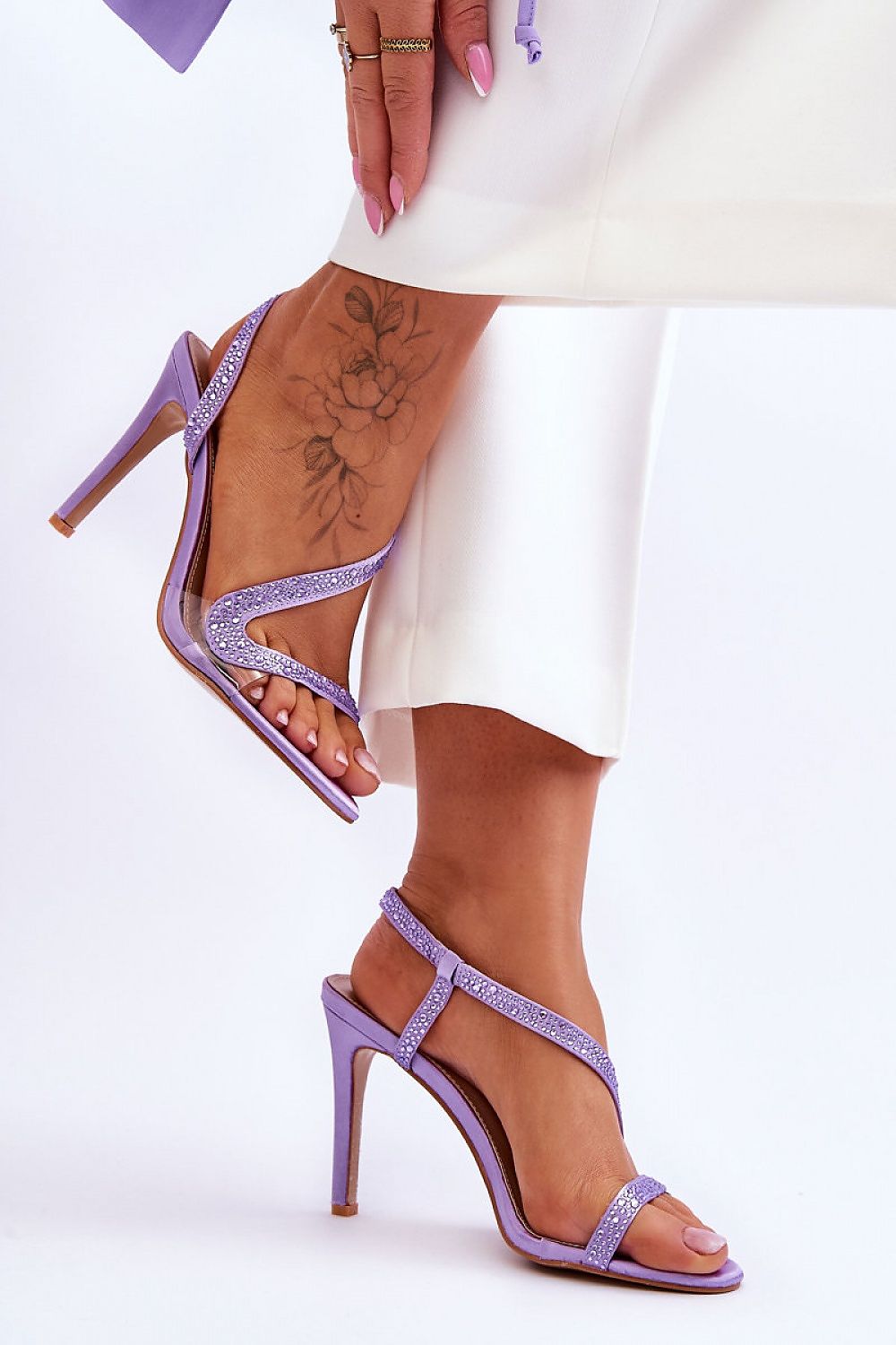 Chic purple strappy heel sandals adorned with shimmering rhinestones, designed for comfort and elegance by Step in Style. Ideal for special occasions.