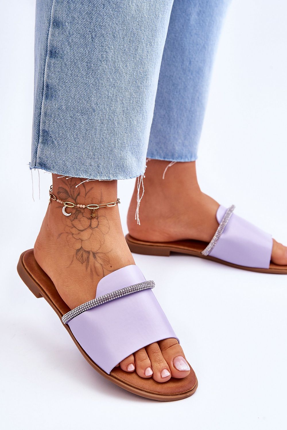 Luxury eco leather flip-flops from Step in Style featuring a chic rhinestone strap, perfectly paired with casual denim for a stylish summer look.