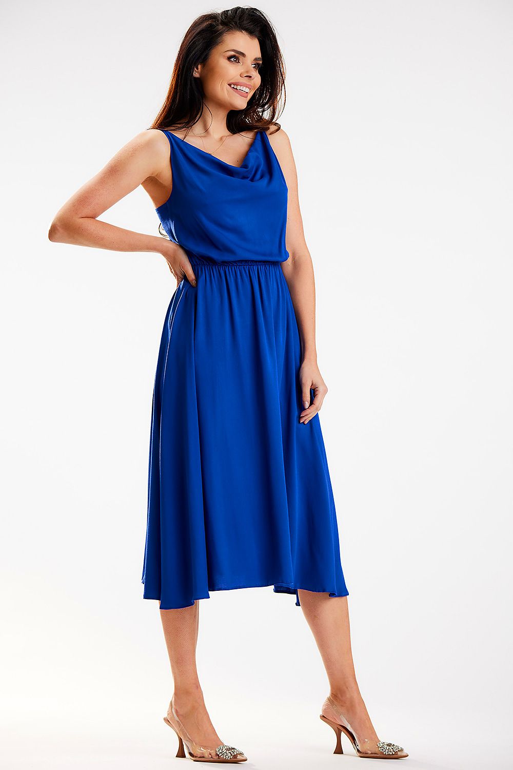 Elegant Awama midi dress showcased in blue, featuring a crinkled neckline and elastic waistband, styled with chic heels, perfect for sophisticated occasions.