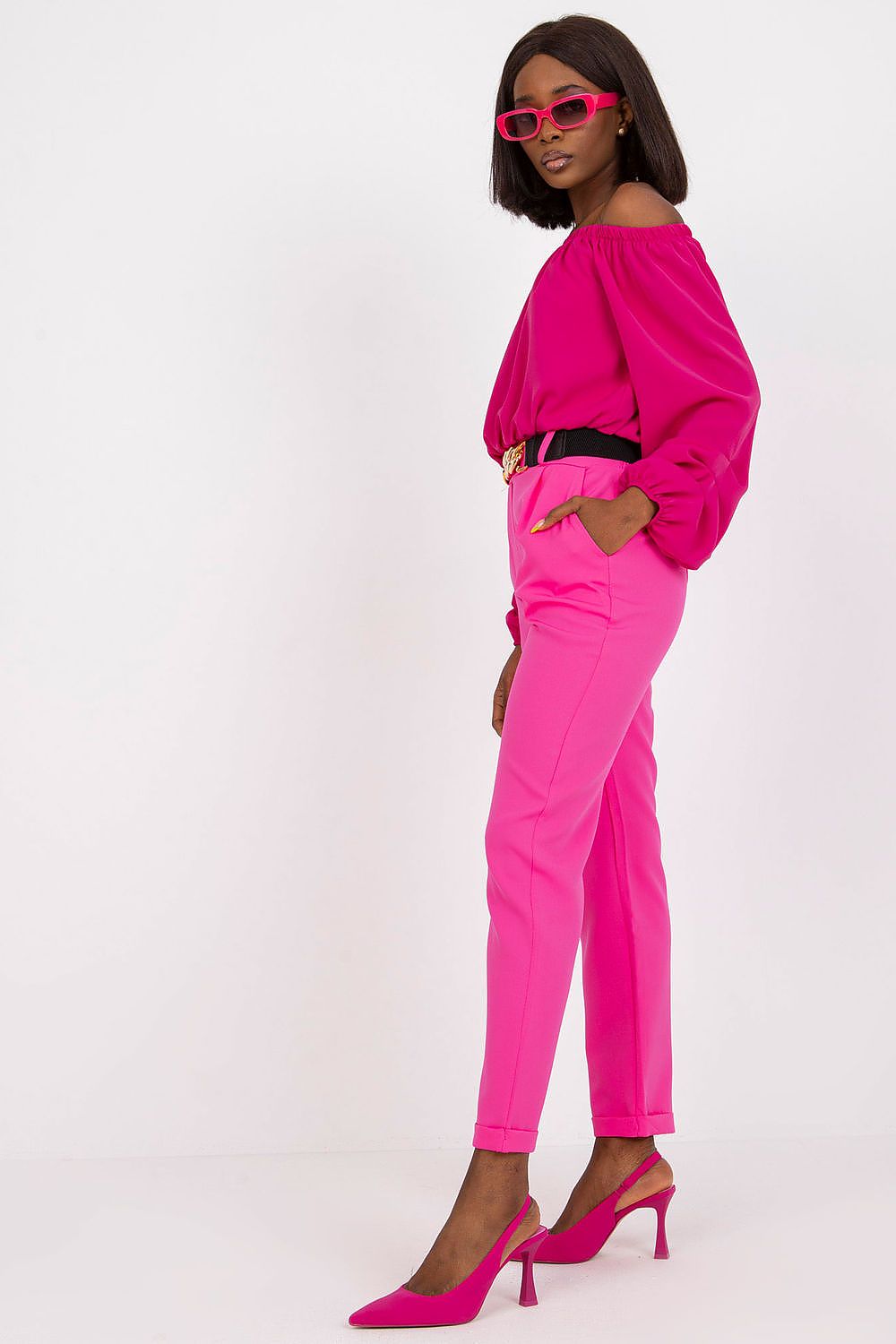 Side view of luxury women's high rise trousers by Italy Moda, elegantly paired with a pink blouse, highlighting the sophisticated silhouette.