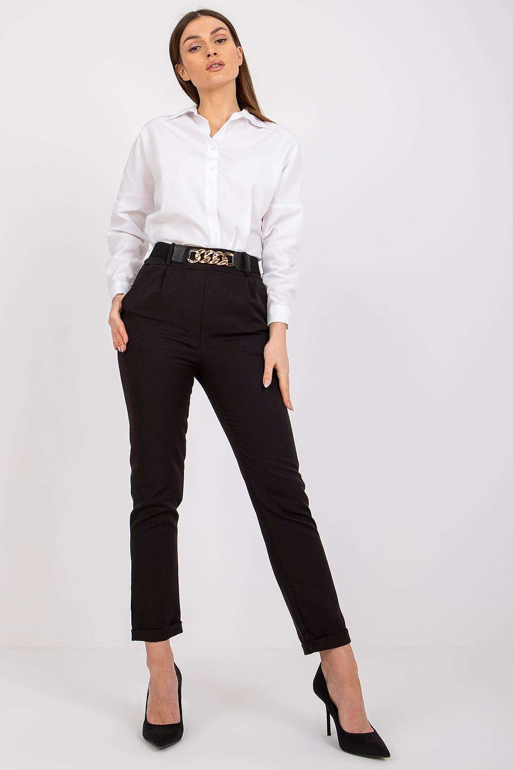 Fashionable woman in luxury women's black high rise trousers by Italy Moda, elegantly dressed in a classic white shirt for a sophisticated look.