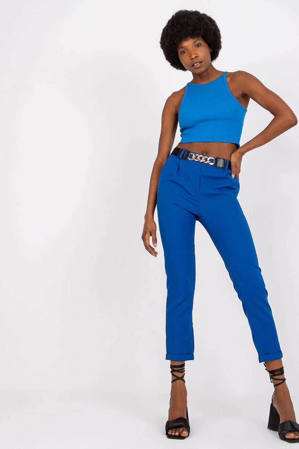 Chic front pose of a model showcasing Luxury Women’s High Rise Trousers by Italy Moda in vibrant blue, paired with a matching crop top and a decorative belt.