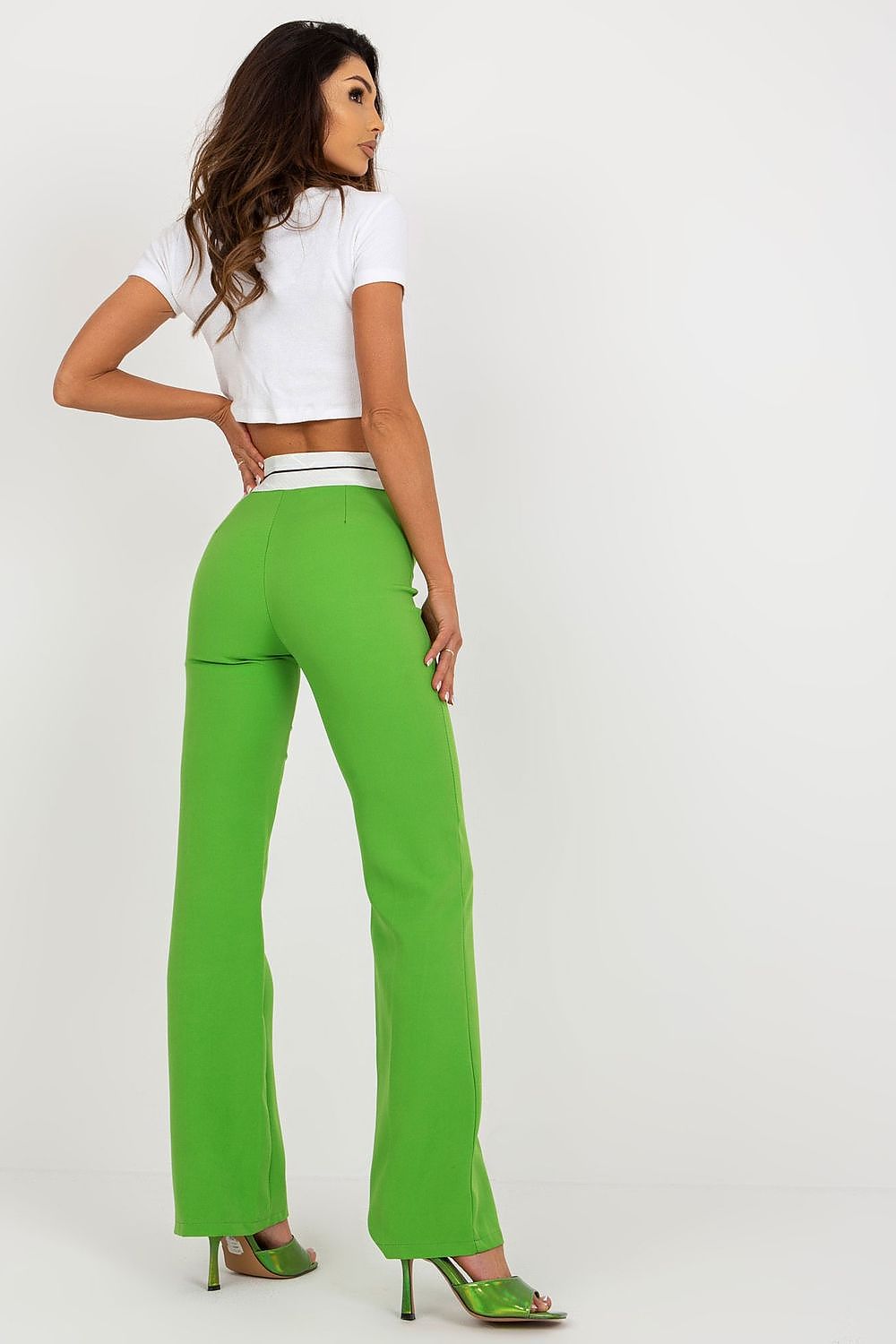 Rear view of high-waisted green trousers by Italy Moda, showcasing a contemporary design, paired with a stylish white top.